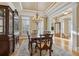 Dining room showcases wood table, hutch, coffered ceiling, and hardwood floors, creating an elegant space at 4385 Old Hamilton Mill Rd, Buford, GA 30518