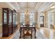 This spacious dining room features detailed wood furniture, decorative ceiling, and hardwood floors at 4385 Old Hamilton Mill Rd, Buford, GA 30518