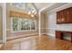Dining room features large bright windows, hardwood floors and an elegant chandelier at 4385 Old Hamilton Mill Rd, Buford, GA 30518