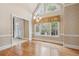 Dining room features large bright windows, hardwood floors and an elegant chandelier at 4385 Old Hamilton Mill Rd, Buford, GA 30518