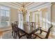 Formal dining room showcasing a large wood table and coffered ceiling with natural light from the many windows at 4385 Old Hamilton Mill Rd, Buford, GA 30518