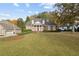 Charming brick home with a manicured lawn, elegant white columns, and mature trees in a serene setting at 4385 Old Hamilton Mill Rd, Buford, GA 30518