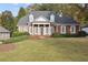 Inviting two-story brick home featuring a symmetrical facade, stately columns, and a well-manicured lawn at 4385 Old Hamilton Mill Rd, Buford, GA 30518