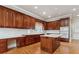 Well-equipped kitchen with white countertops, wooden cabinets, and hardwood flooring at 4385 Old Hamilton Mill Rd, Buford, GA 30518