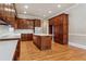 Spacious kitchen showcasing wooden cabinets, an island, and stainless steel appliances at 4385 Old Hamilton Mill Rd, Buford, GA 30518