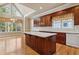 Spacious kitchen features a large island, lots of cabinet space, bright windows and hardwood floors at 4385 Old Hamilton Mill Rd, Buford, GA 30518
