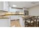 Kitchen featuring granite countertops, white cabinetry, and stainless steel appliances at 4385 Old Hamilton Mill Rd, Buford, GA 30518