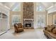 Living room with stone fireplace, plush seating, and abundant natural light at 4385 Old Hamilton Mill Rd, Buford, GA 30518