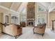 Bright living room featuring a stone fireplace, high ceilings, and elegant furnishings at 4385 Old Hamilton Mill Rd, Buford, GA 30518