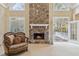 Inviting living room with stone fireplace, large windows, and access to an outdoor balcony at 4385 Old Hamilton Mill Rd, Buford, GA 30518