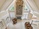 Spacious living room with fireplace, tall windows, and soaring ceilings providing ample natural light at 4385 Old Hamilton Mill Rd, Buford, GA 30518
