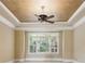 Main bedroom featuring tray ceilings, ceiling fan and many bright windows at 4385 Old Hamilton Mill Rd, Buford, GA 30518