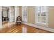 Sitting room with hardwood floors, white trim, bright windows, and vintage furniture at 4385 Old Hamilton Mill Rd, Buford, GA 30518