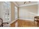 Bright sitting room features hardwood floors, plantation shutters, and a vintage-style chair at 4385 Old Hamilton Mill Rd, Buford, GA 30518
