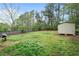 Large, grassy backyard with a shed and mature trees at 1601 Sycamore Nw Dr, Kennesaw, GA 30152