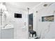 Bathroom with glass shower, double vanity, marble accents, and wall-mounted TV at 1601 Sycamore Nw Dr, Kennesaw, GA 30152