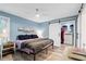 Bedroom with beach-themed decor, ceiling fan, and barn door closet at 1601 Sycamore Nw Dr, Kennesaw, GA 30152