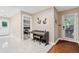 View of a stylish entryway with a piano, white tile floors, and neutral walls at 1601 Sycamore Nw Dr, Kennesaw, GA 30152