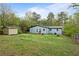 Back exterior of home with an ample backyard and storage shed at 1601 Sycamore Nw Dr, Kennesaw, GA 30152