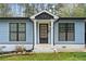 A close up of the front of the light blue home with black trim and a well manicured front yard at 1601 Sycamore Nw Dr, Kennesaw, GA 30152