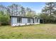 Lovely one-story home featuring a light blue exterior, black trim, and well-kept lawn at 1601 Sycamore Nw Dr, Kennesaw, GA 30152