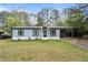 Charming light blue one-story home with well-manicured lawn and covered carport at 1601 Sycamore Nw Dr, Kennesaw, GA 30152