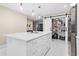 Large white kitchen island with drawers and pendant lights; pantry behind barn door at 1601 Sycamore Nw Dr, Kennesaw, GA 30152