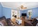 A comfortable living room with hardwood floors, cozy seating, and a ceiling fan at 1601 Sycamore Nw Dr, Kennesaw, GA 30152