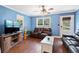 Cozy living room with hardwood floors, leather seating, and ample natural light at 1601 Sycamore Nw Dr, Kennesaw, GA 30152