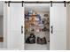 Walk-in pantry with shelving, barn door, and ample storage space at 1601 Sycamore Nw Dr, Kennesaw, GA 30152