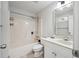 Well-lit bathroom with a tub and shower combination and a classic white vanity at 2973 Heavenly Ln, Snellville, GA 30078