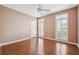 Spacious bedroom with hardwood flooring, two large windows with shutters, and ceiling fan at 2973 Heavenly Ln, Snellville, GA 30078