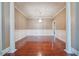 Bright dining room featuring hardwood floors, decorative columns, and contemporary lighting at 2973 Heavenly Ln, Snellville, GA 30078