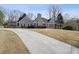 View of the home featuring a wide driveway and a landscaped yard in a well-maintained neighborhood at 2973 Heavenly Ln, Snellville, GA 30078
