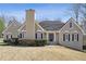 Charming home featuring a neutral color palette, black shutters, chimney, and well-manicured landscaping at 2973 Heavenly Ln, Snellville, GA 30078