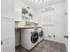 A practical laundry room with machines and plenty of shelving at 2973 Heavenly Ln, Snellville, GA 30078