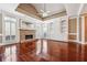 Bright living room featuring a stone fireplace, hardwood floors, and coffered ceilings at 2973 Heavenly Ln, Snellville, GA 30078