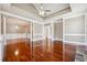 Open floor plan living room featuring hardwood floors, decorative columns, and coffered ceilings at 2973 Heavenly Ln, Snellville, GA 30078