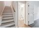View of the stairway with wood handrail that leads to the upper level at 2973 Heavenly Ln, Snellville, GA 30078