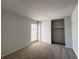Bedroom featuring neutral carpet, window, and closet with sliding doors at 3156 Nectarine Cir, Decatur, GA 30034
