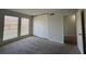 Light-filled bedroom features neutral carpet, two windows, and a closet with sliding doors at 3156 Nectarine Cir, Decatur, GA 30034