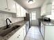 Updated kitchen featuring granite countertops, stainless steel appliances, and white cabinets at 3156 Nectarine Cir, Decatur, GA 30034