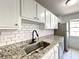 Kitchen with granite countertops, stainless steel appliances, and matte black faucet at 3156 Nectarine Cir, Decatur, GA 30034