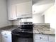 Open concept kitchen with a breakfast bar and stainless steel oven at 3156 Nectarine Cir, Decatur, GA 30034