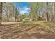 Extensive backyard with mature trees, outbuildings, and an open lawn at 4670 Sundridge Trl, Fairburn, GA 30213