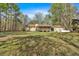 The home features a screened-in back porch, a propane tank, and a large, grassy, unfenced yard at 4670 Sundridge Trl, Fairburn, GA 30213