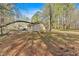 Backyard view with mature trees and a shed in a wooded setting at 4670 Sundridge Trl, Fairburn, GA 30213