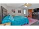 Comfortable bedroom with a large tufted headboard, ceiling fan, closet, and TV at 4670 Sundridge Trl, Fairburn, GA 30213