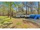Detached two-car garage, offering plenty of storage and parking, alongside a grassy lawn and mature trees at 4670 Sundridge Trl, Fairburn, GA 30213