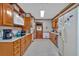 Traditional kitchen features wooden cabinets, modern appliances, and tiled flooring at 4670 Sundridge Trl, Fairburn, GA 30213